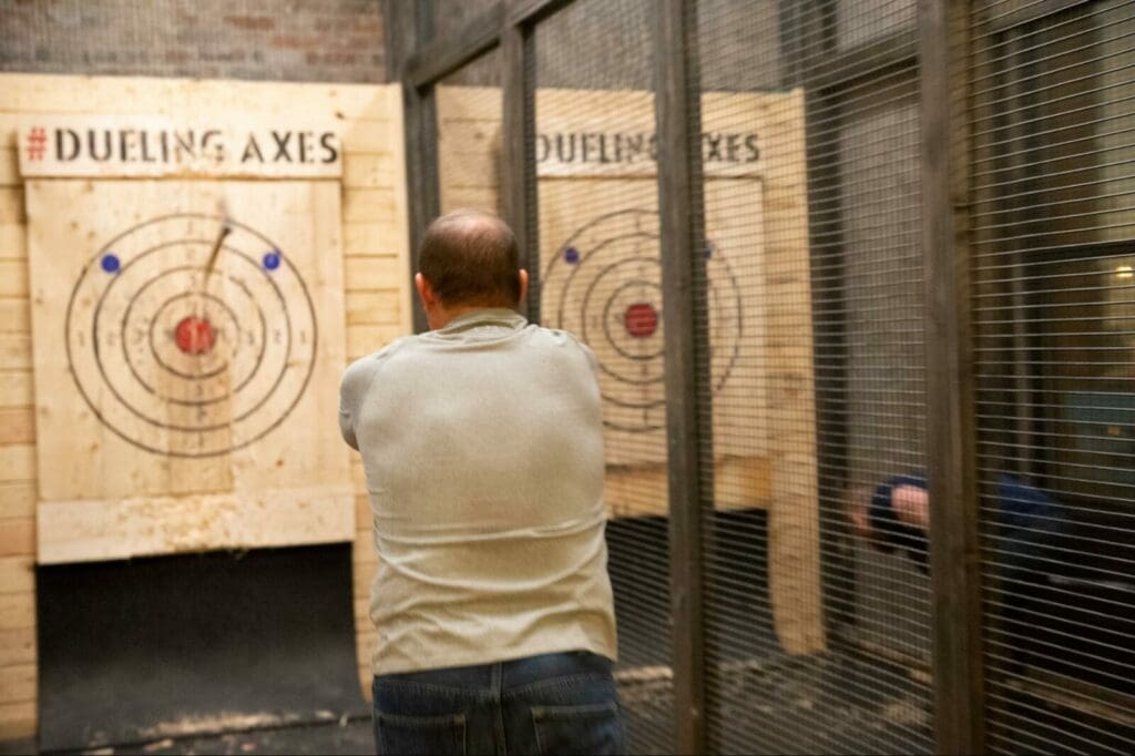 Man using axe throwing techniques at Dueling Axes' lounge and bar